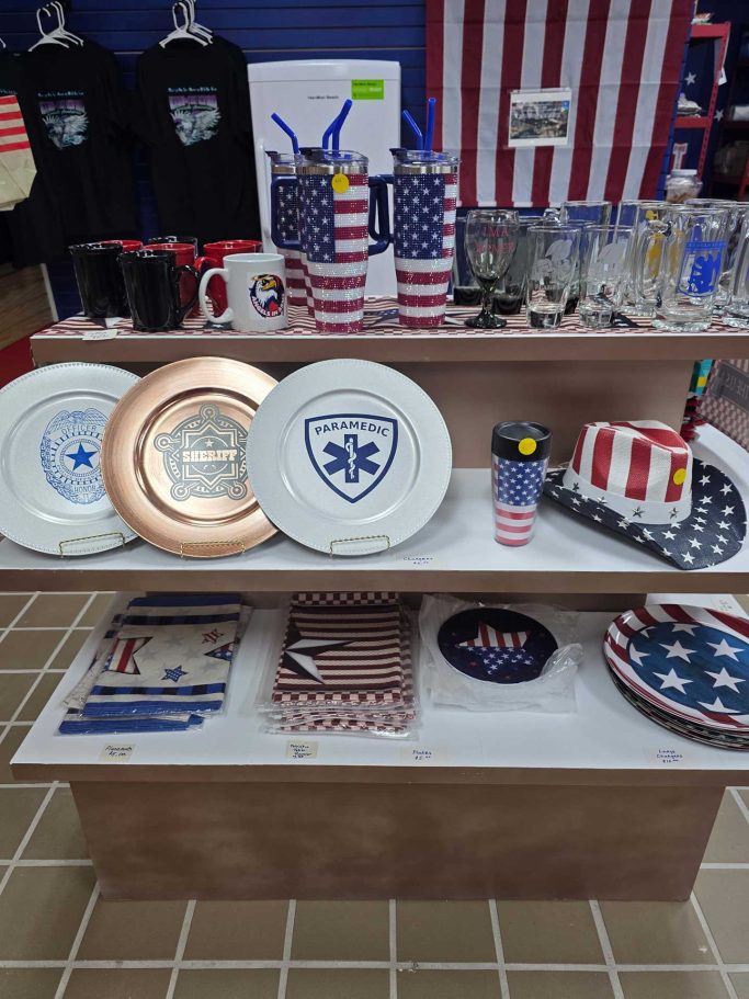 Shelf of commemorative plates and glassware image